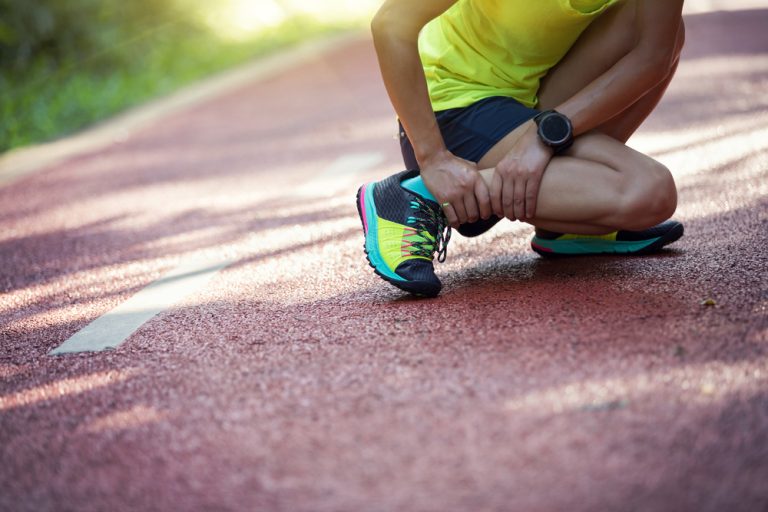Female runner suffering with pain on sports running injury